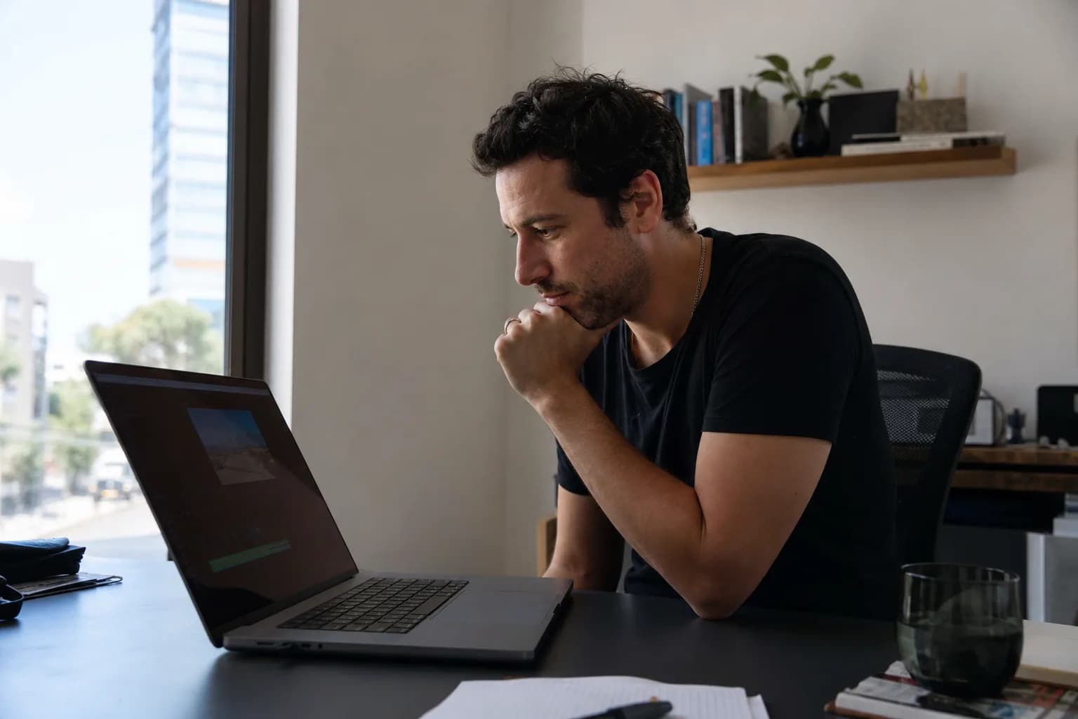 A small business owner planning an A/B test for a video ad in his office.