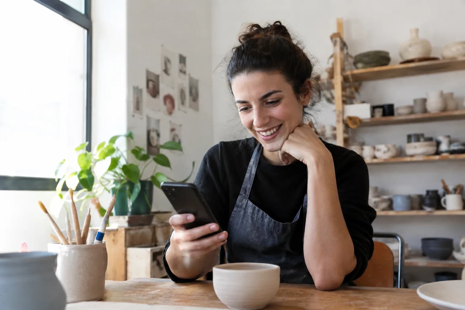 A small business owner reviews her short video branding strategy on her smartphone.